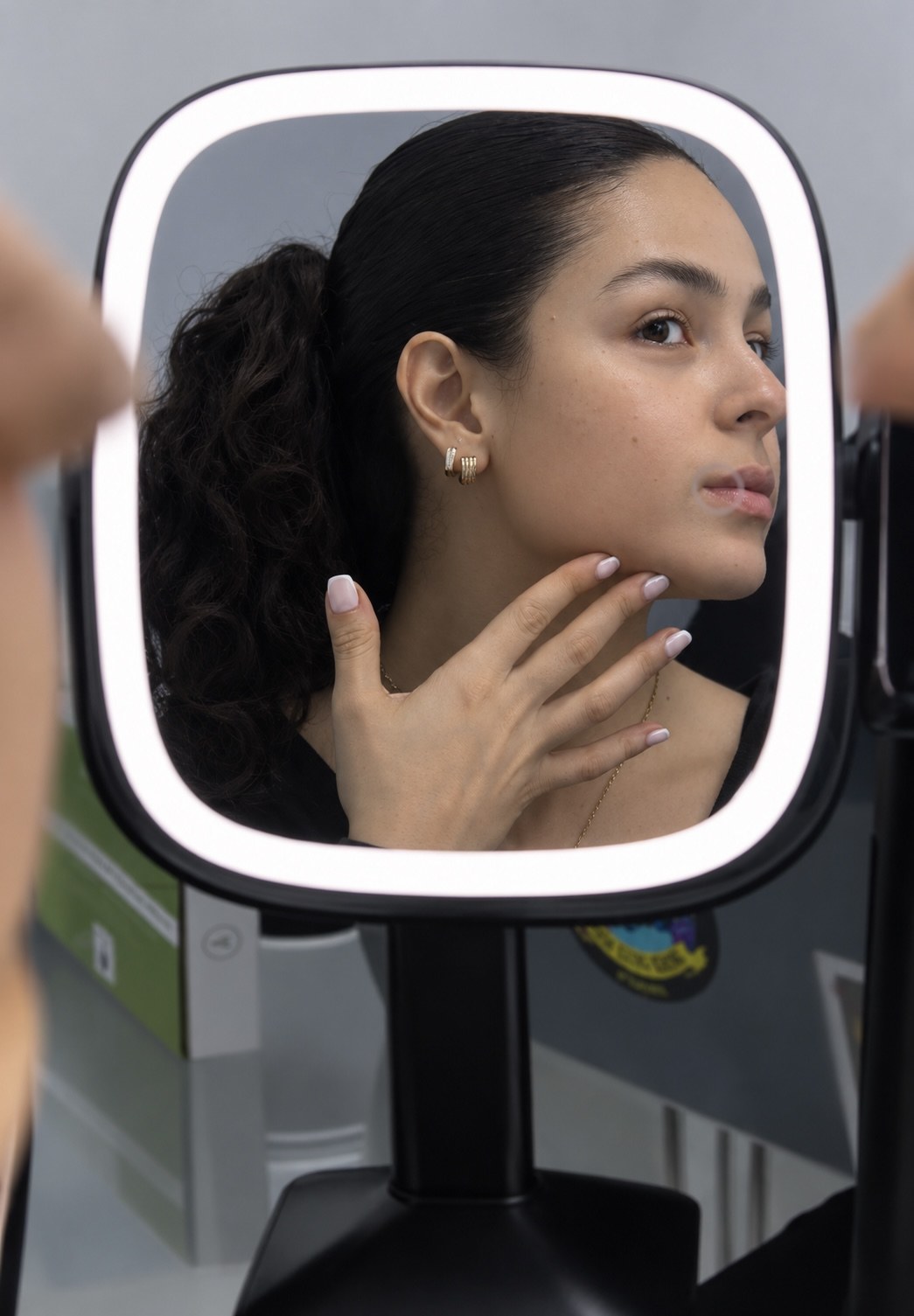 Paciente observando su rostro durante una evaluación personalizada en la clínica